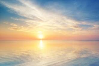 a tranquil view of the sunset over a large body of water