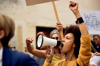 a woman with a megaphone at a protest