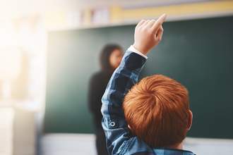 a-student-raises-his-hand-to-answer-a-question