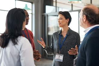 a-woman-chats-with-colleagues