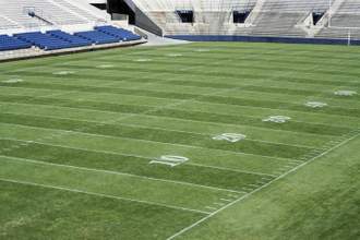 above view of a green football field in a stadium