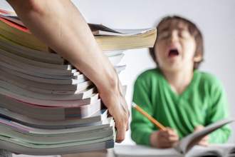 adult dropping off a stack of study materials in front of child who looks very upset