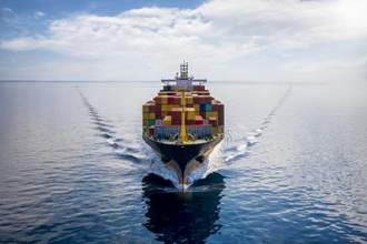 aerial front view of a loaded container cargo vessel