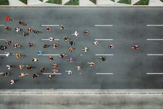 aerial shoot of a group of people running on the streets