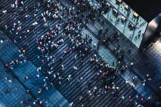 aerial view of crowded pedestrians walking on the business street at night