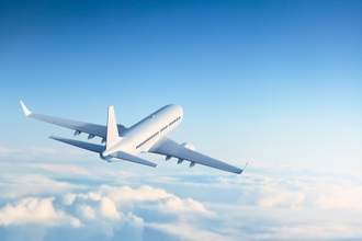 airplane taking off flying over the clouds
