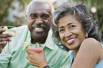 an older couple celebrating their anniversary with drinks in hand