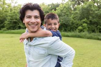 an uncle giving his nephew a piggy back ride