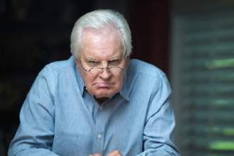 angry looking old man looking directly into the camera