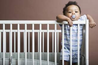 baby boy standing in cot
