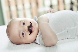 baby wearing a fake mustache