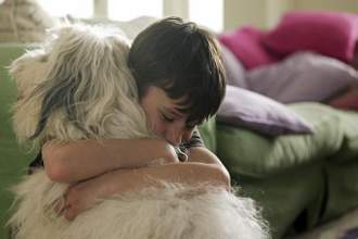 boy hugging his dog
