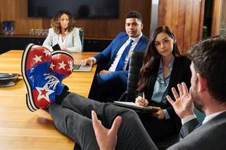 business man speaking in a meeting wearing clown shoes