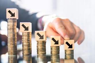 business mans hands gliding atop arrows on top of coins going in a downwards direction