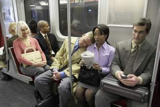 business woman on a train looking uncomfortable as a stranger falls asleep on her shoulder