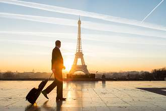 business-man-with-suitcase-in-front-of-eiffel-tower
