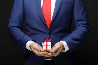 businessman holding a small gift in his hands