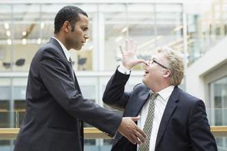 businessman making face at co-worker