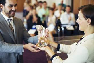 businessman receiving an award from a fellow coworker
