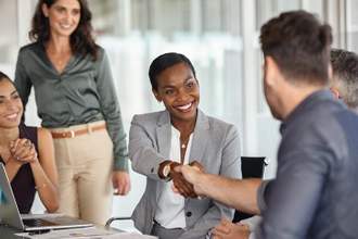 businesswoman shaking hands with new business partner