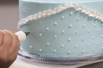 cake being decorated by hand