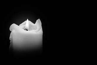 candle burning in black and white