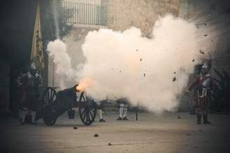 canon being shot with cloud of smoke