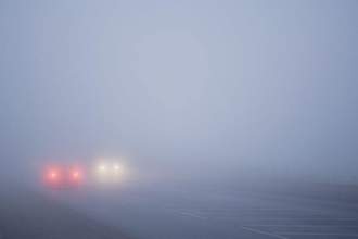 cars driving in thick fog