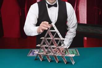 casino dealer with house of cards
