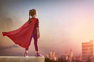 child superhero looking off into the distance