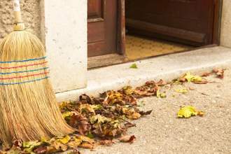 close up of broom against house threshold