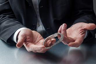 close up of hands selling a watch