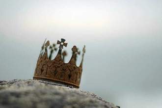 close up of rusted crown on rock