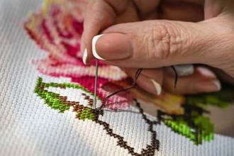close up view of someone working on the embroidery process