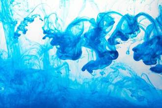 closeup of a blue ink in water in motion