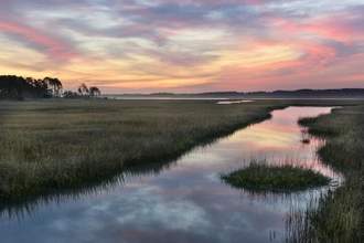 clouds reflecting in water of salt marsh