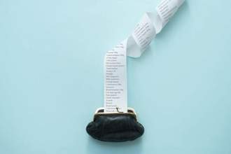 coin purse with a long list of groceries coming out of it
