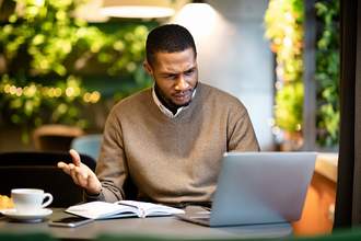 confused man looking at computer