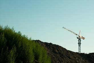 construction crane rising over hill