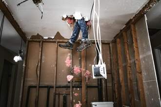 contractors legs bursting through the ceiling after falling while renovating