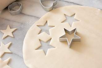 cookie cutter cutting out star shapes