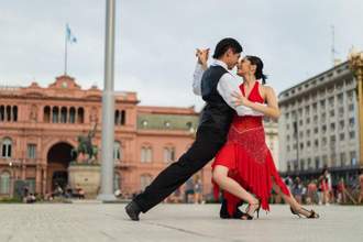 couple dancing tango in a city square