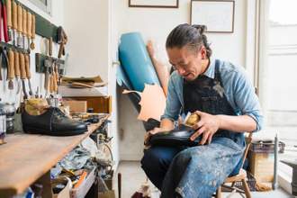craftsman repairing a pair of shoes
