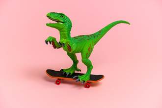 dinosaur toy riding skateboard