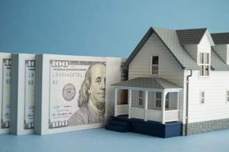 doll house next to bundles of cash