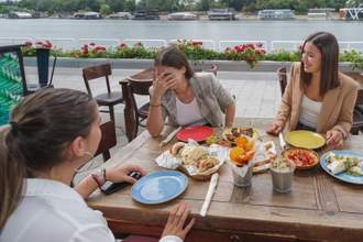 embarrassed young woman laughing with friends