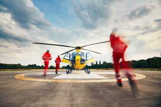 emergency personnel rushing to their helicopter