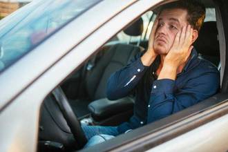 exasperated young man sitting in traffic
