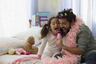 father and daughter singing together and having a party in her bedroom