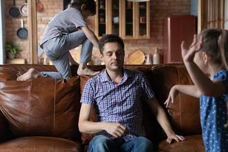 father annoyed by wild children